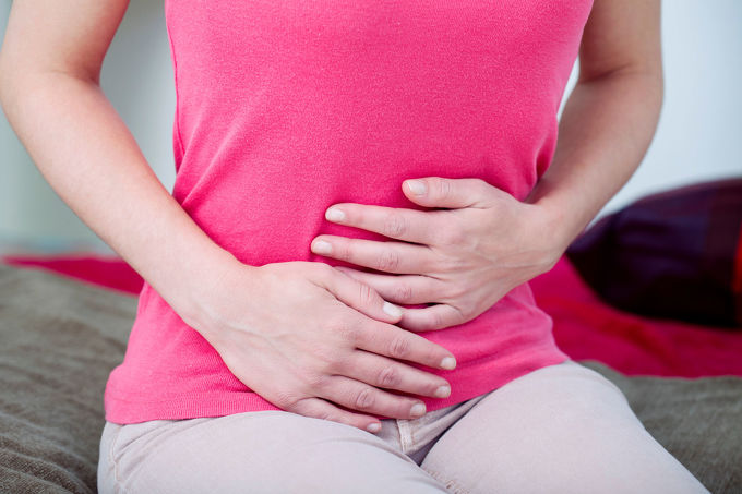 woman holding pelvic area