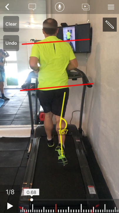 Man running on treadmill with lines assessing their form